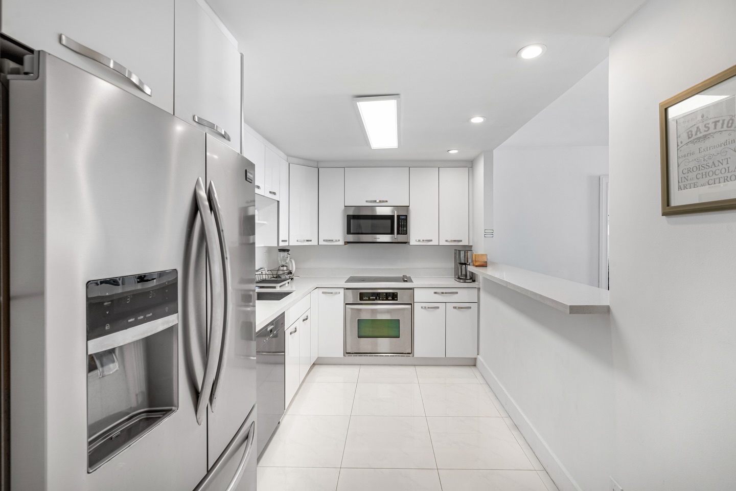 Classic white kitchen with stainless French-door refrigerator